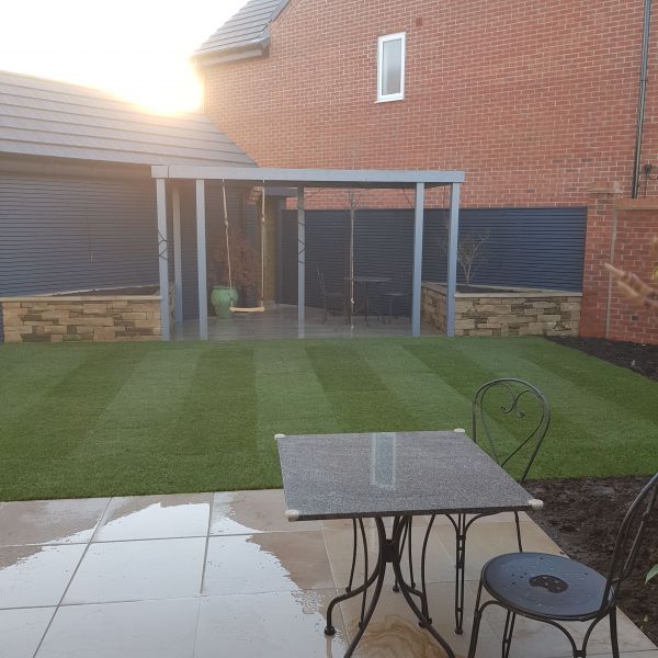 Small project in Edwalton, Nottingham. Timber pergola painted, Dry stone wall raised beds, new lawn and high end natural stone paving : Swipe To View More Images