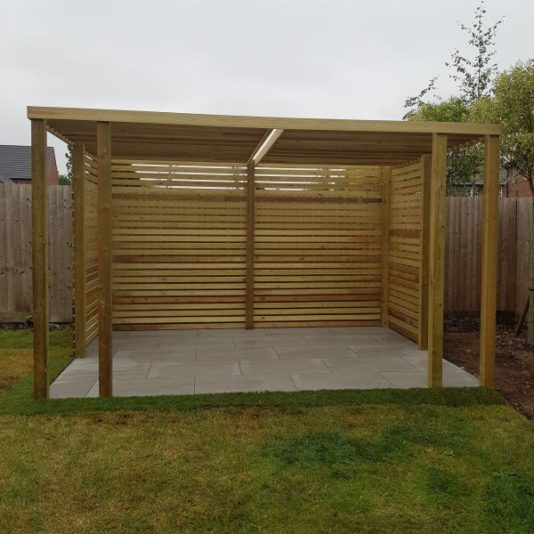 Small outdoor dining area in West Bridgford. Plained timber pergola to provide shade and Porcelain paving.: Swipe To View More Images