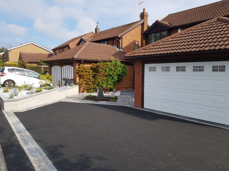 Lovely driveway in Nottingham. Limestone sett edgings with black tarmac and Porcelain paving to the front door.: Swipe To View More Images